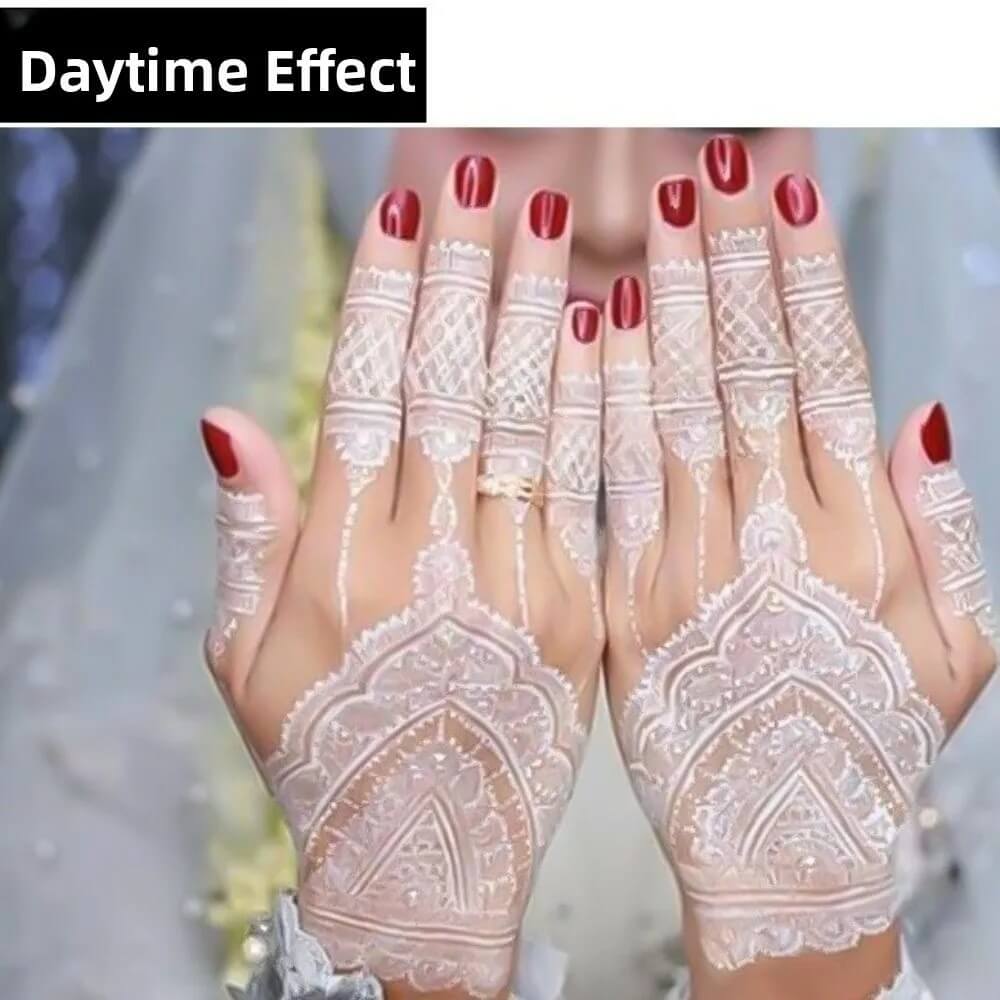 Close-up of hands with white henna designs on a blurred background